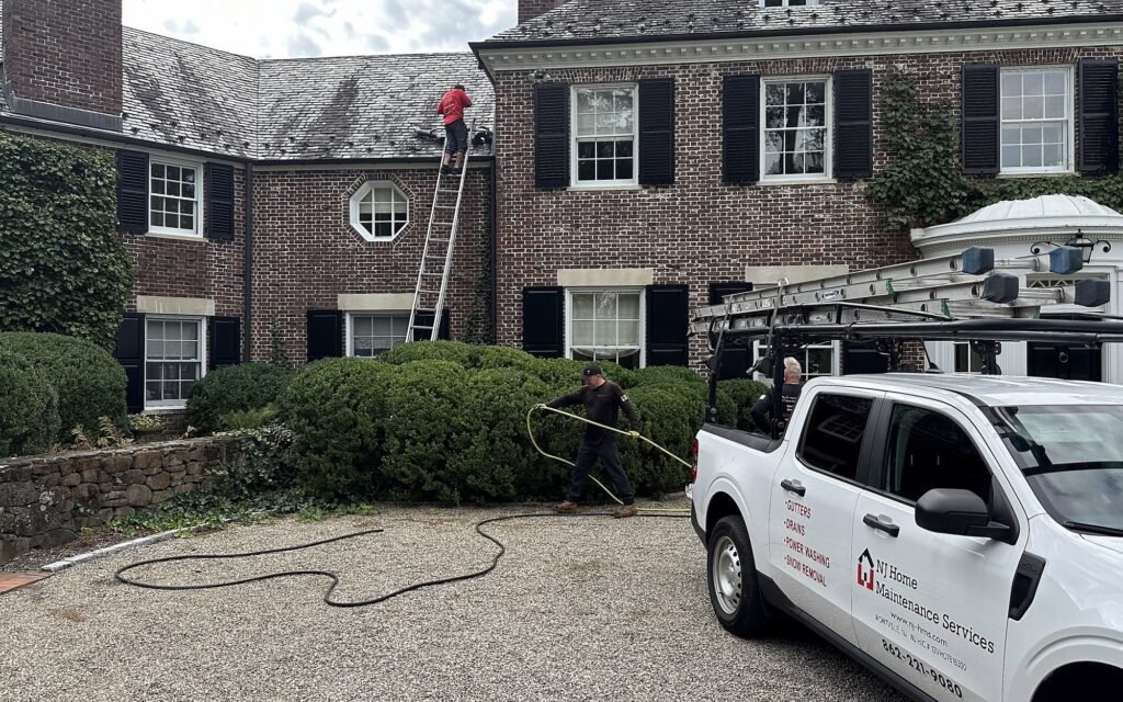 NJHMS crew and work truck at a brick home during a gutter cleaning in Green Village, NJ