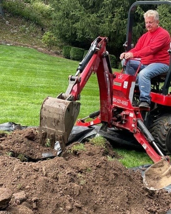 NJHMS crew with a mini excavator installing underground drainage