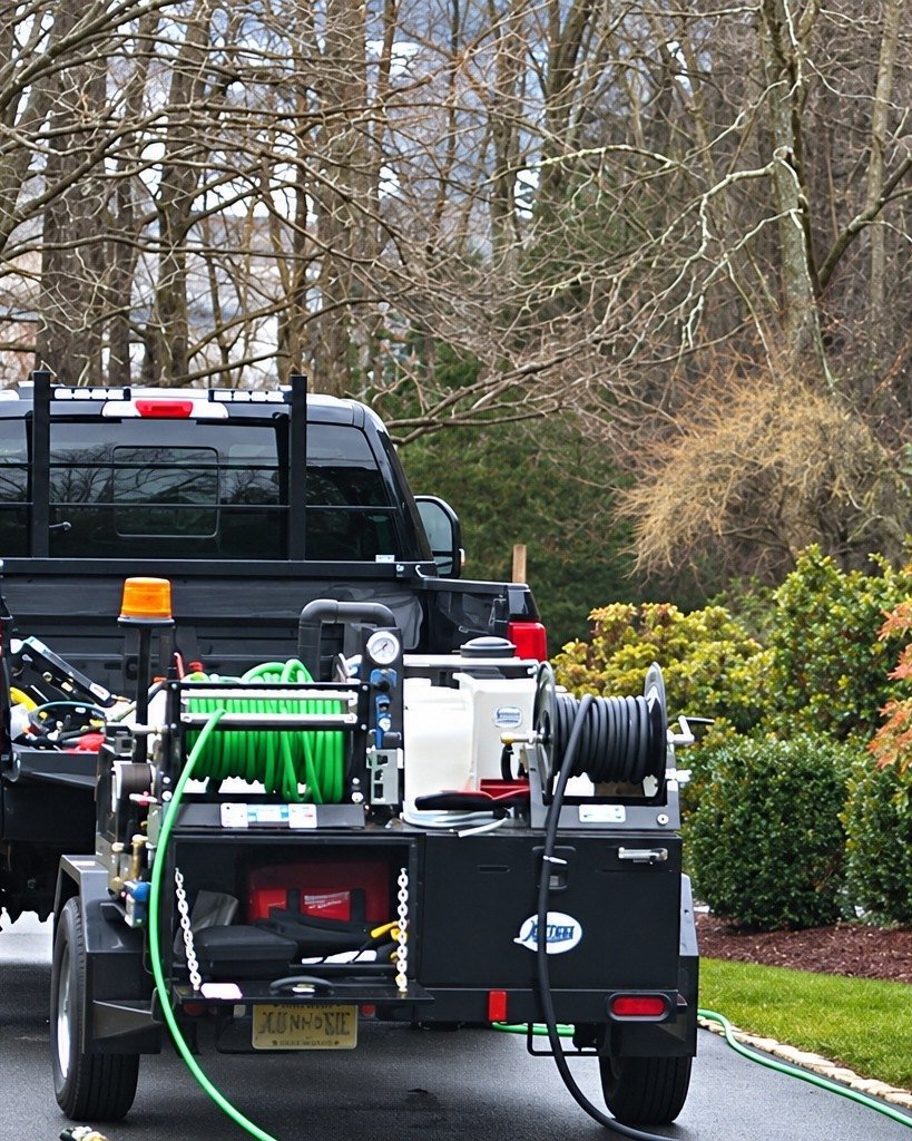NJHMS work truck and hydro jetter trailer in a driveway